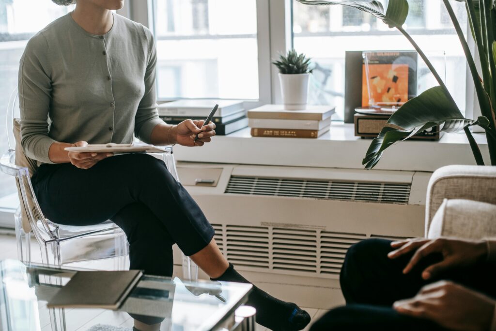 Psychologist consulting a patient in a modern office, emphasizing confidentiality and care.